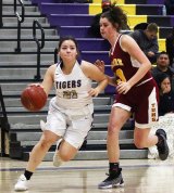 Lemoore's Janay Avalos drives the lane against Tulare's Lindsey Beck in first half of Tuesday's home game against The Tribe. 